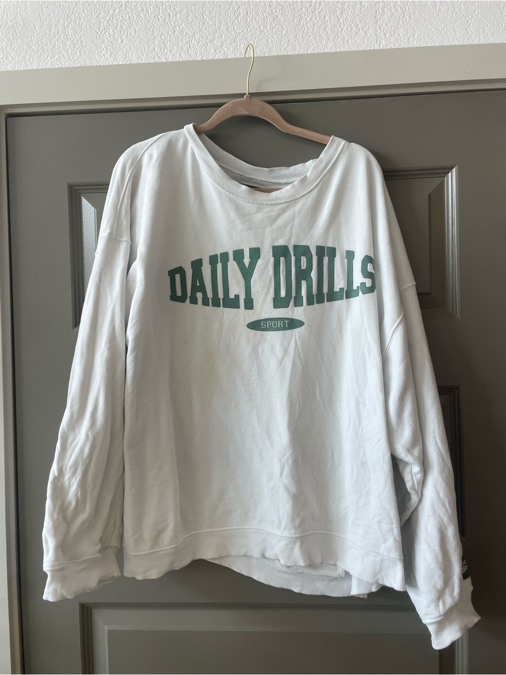 White "Daily Drills" Graphic Sweatshirt in Green Text